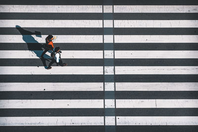 High angle view of people crossing road