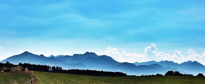 Scenic view of landscape against cloudy sky