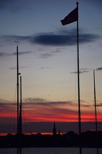 Sailboats sailing on sea against cloudy sky during sunset