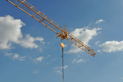 Low angle view of crane against sky