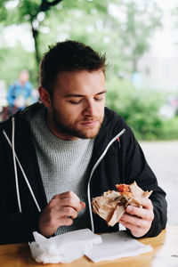 Man eating food on table