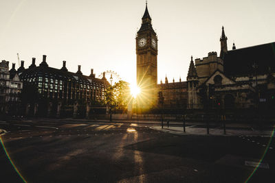 View of buildings in city at sunset