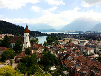 Town by buildings in city against sky