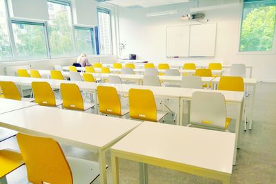 Rear view of woman sitting in classroom