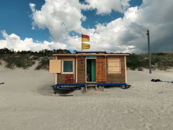 Lifeguard hut on road against sky