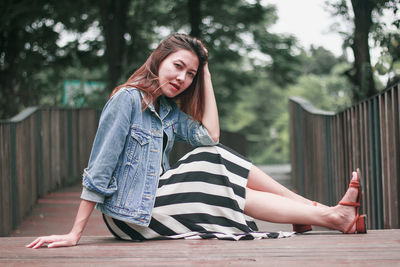 Portrait of young woman sitting outdoors