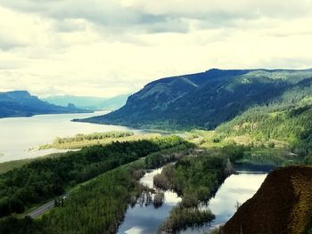 Scenic view of lake and mountains against sky