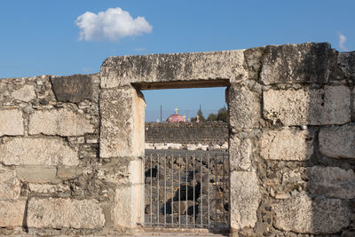 Low angle view of historical building against cloudy sky