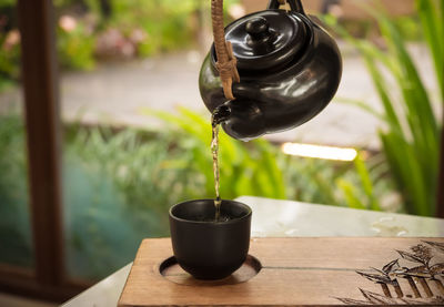 Hand pour chinese or japanese traditional tea from clay pot