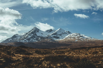 Scenic view of snowcapped mountains against sky