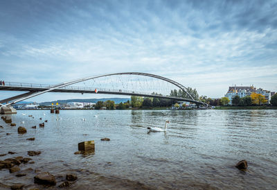 View of bridge over river against cloudy sky