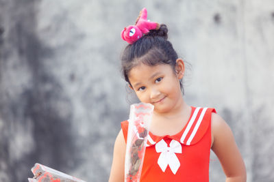 Portrait of cute girl against blurred background