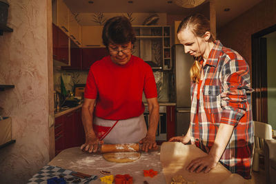 Woman standing on table at home