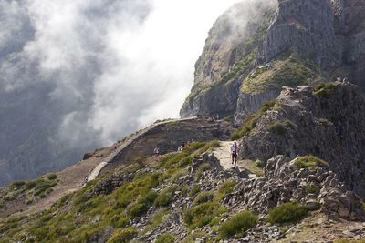 Hiker walking on rocky mountains