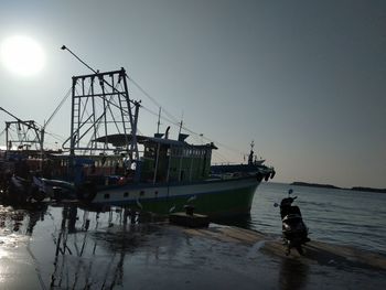 Ship moored at harbor against clear sky