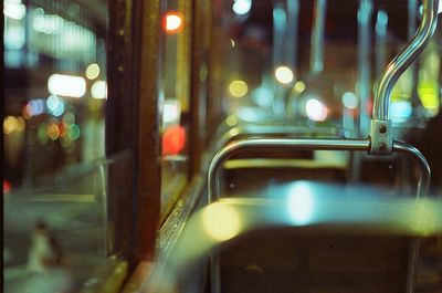 Close-up of illuminated lighting equipment on street in city