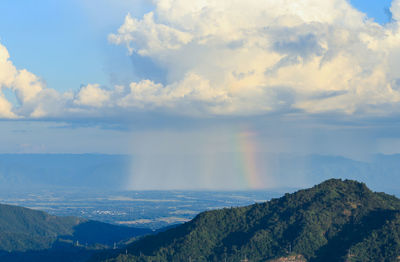 Scenic view of rainbow over mountains against sky