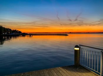 Pier over sea against sky during sunset