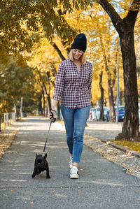 Man with dog walking on street