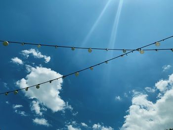 Low angle view of cables against blue sky