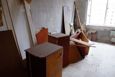Empty chairs and table in old building