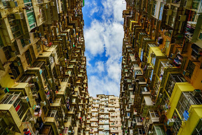 Low angle view of residential building against cloudy sky