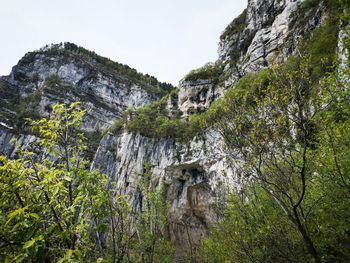 Low angle view of rocks on mountain against sky