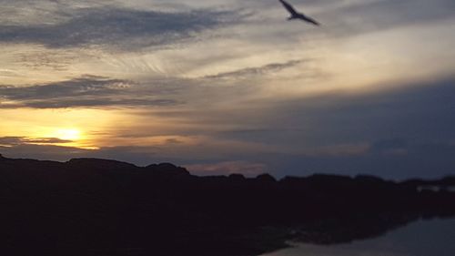 Scenic view of silhouette mountains against sky during sunset