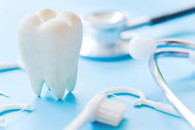 Close-up of dental equipment over blue background