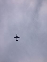 Low angle view of airplane flying in sky