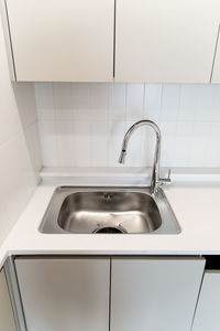 Close-up of faucet in bathroom at home