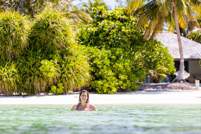 Middle aged woman in the water on a resort beach