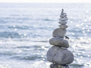 Pyramid of pebbles and stones on beach. sunny day at seaside. leisure on ocean coast.