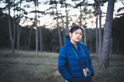 Portrait of woman standing in forest