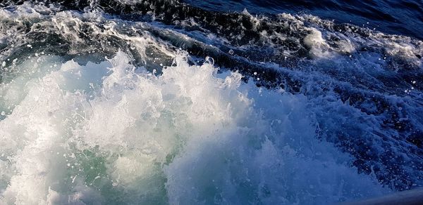 High angle view of waves splashing on sea