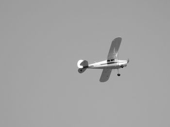 Low angle view of airplane against clear sky