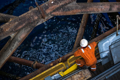 High angle view of worker offshore platform in ocean