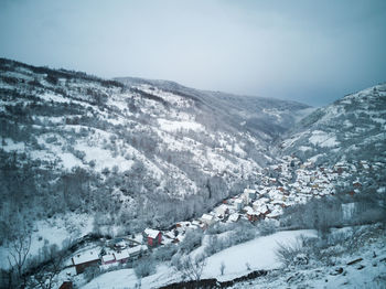 Scenic view of snow covered mountains against sky