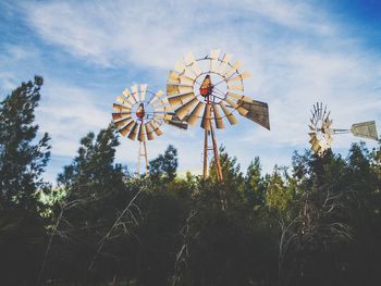 Low angle view of traditional windmill against sky