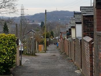 Street amidst buildings against sky