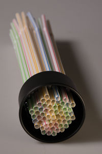 High angle view of colorful straws on gray background