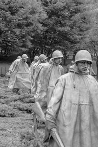 Rear view of people standing on field