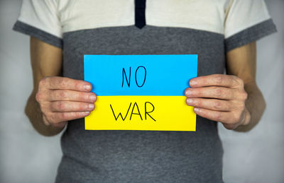 Midsection of man holding banner