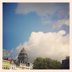 Low angle view of buildings against cloudy sky