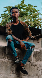 Portrait of young man sitting outdoors