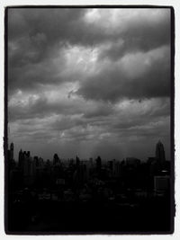 Cityscape against cloudy sky