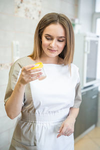 Portrait of young woman using mobile phone