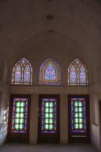 Low angle view of stained glass window in building