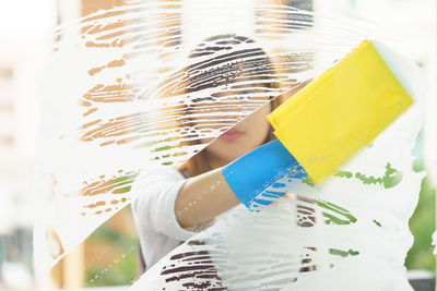 Woman washing glass window