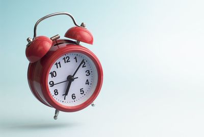 Low angle view of clock against white background